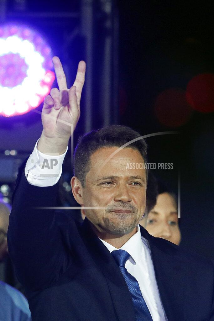 Petr David Josek Presidential candidate Rafal Trzaskowski flashes a victory sign at the end of the election day in Warsaw, Poland, Sunday, July 12, 2020. Voting ended in Poland's razor-blade-close presidential election runoff between the conservative incumbent Andrzej Duda and liberal, pro-European Union Warsaw Mayor Rafal Trzaskowski with exit polls showing the election is too close to call. (AP Photo/Petr David Josek)
