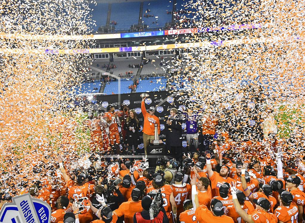 Ken Ruinard Clemson coach Dabo Swinney raises the Atlantic Coast Conference championship trophy after the team's win over Virginia in an NCAA college football game in Charlotte, N.C., Saturday, Dec. 7, 2019. (Ken Ruinard/The Independent-Mail via AP)