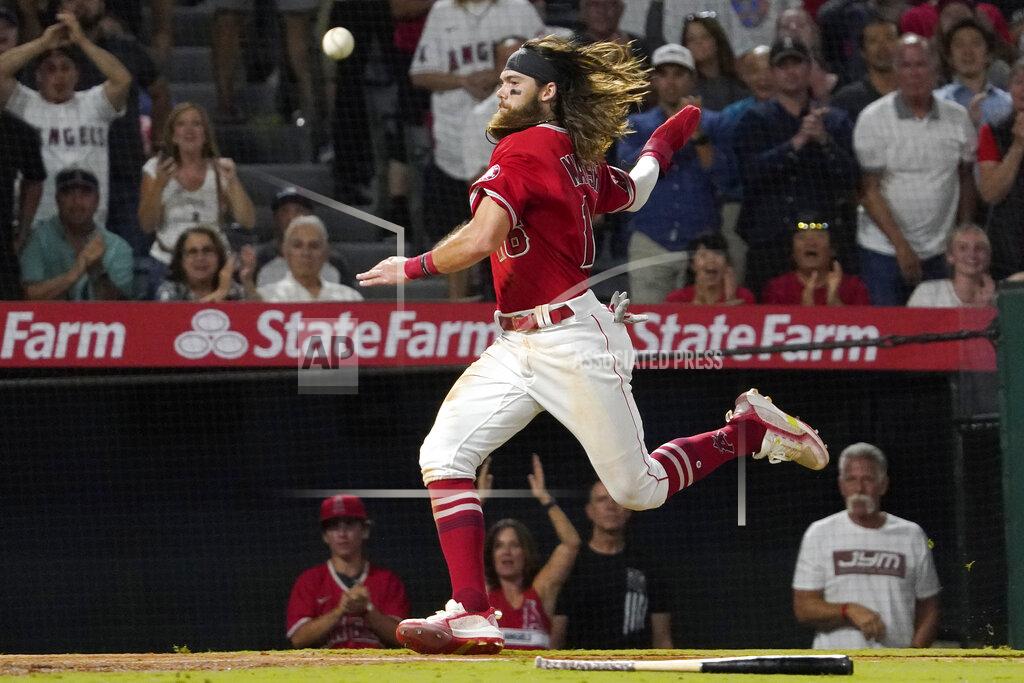 Mark J. Terrill The ball goes by Los Angeles Angels' Brandon Marsh before he scores on a three RBI double by Jack Mayfield during the seventh inning of a baseball game against the Houston Astros Wednesday, Sept. 22, 2021, in Anaheim, Calif. (AP Photo/Mark J. Terrill)