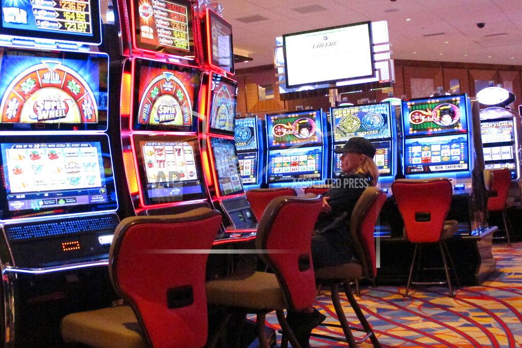 Wayne Parry In this June 20, 2019 photo, a gambler plays a slot machine at the Hard Rock Casino in Atlantic City, N.J. Casinos in several states are considering safety measures including turning off every second or third slot machine in order to keep gamblers separated once they reopen from shutdowns mandated by the coronavirus outbreak. (AP Photo/Wayne Parry)