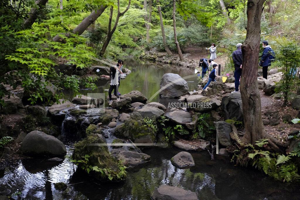 Kiichiro Sato In this April 22, 2020, photo, despite the government request to stay home, people visit Arisugawa Park in Tokyo. Under Japan's coronavirus state of emergency, people have been asked to stay home. Many are not. Some still have to commute to their jobs despite risks of infection, while others are dining out, picnicking in parks and crowding into grocery stores with scant regard for social distancing. (AP Photo/Kiichiro Sato)