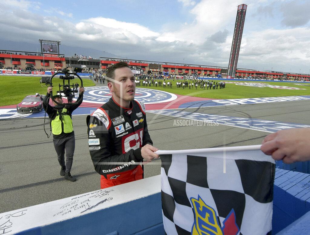 Will Lester Alex Bowman accepts the checkered flag from an official after winning a NASCAR Cup Series auto race Sunday, March 1, 2020 in Fontana, Calif. (AP Photo/Will Lester)