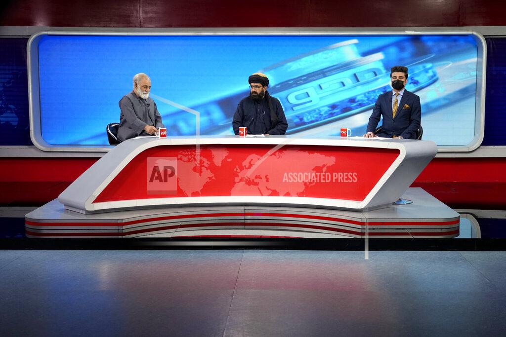 Ebrahim Noroozi TV anchor Nesar Nabil wears a face mask to protest the Taliban's new order that female presenters cover their faces, as he reads the news on TOLOnews, in Kabul, Afghanistan, Sunday, May 22, 2022. Afghanistan's Taliban rulers have begun enforcing an order requiring all female TV news anchors in the country to cover their faces while on-air. The move Sunday is part of a hard-line shift drawing condemnation from rights activists. (AP Photo/Ebrahim Noroozi)