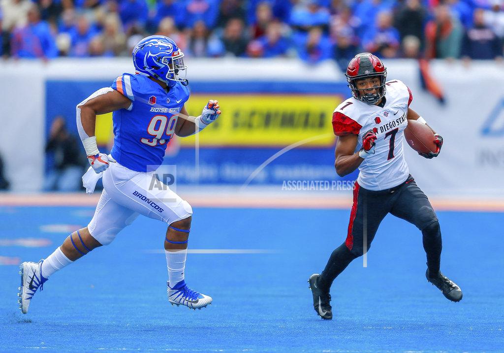 Steve Conner San Diego State wide receiver Fred Trevillion, right, turns up field after a reception as Boise State linebacker Curtis Weaver, left, gives chase in the first half of an NCAA college football game, Saturday, Oct. 6, 2018, in Boise, Idaho. (AP Photo/Steve Conner)