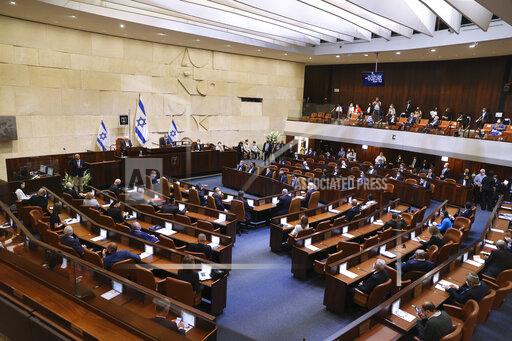 Alex Kolomoisky Israeli lawmakers attend the swearing-in ceremony for Israel's 24th government, at the Knesset, or parliament, in Jerusalem, Tuesday, April 6, 2021. The ceremony took place shortly after the country's president asked Prime Minister Benjamin Netanyahu to form a new majority coalition, a difficult task given the deep divisions in the fragmented parliament. (Alex Kolomoisky/Pool via AP)