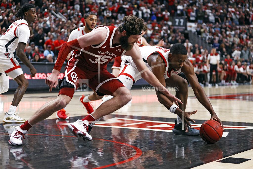 Brad Tollefson Oklahoma's Tanner Groves (35) and Texas Tech's Bryson Williams (11) dive for the ball during the first half of an NCAA college basketball game Tuesday, Feb. 22, 2022, in Lubbock, Texas. (AP Photo/Brad Tollefson)