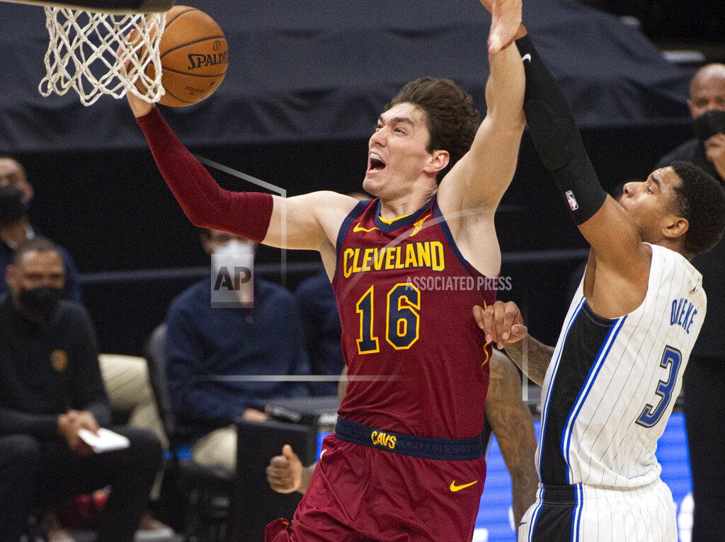 Phil Long Cleveland Cavaliers' Cedi Osman (16) drives past Orlando Magic's Chuma Okeke for a basket during the third quarter of an NBA basketball game Wednesday, April 28, 2021 in Cleveland. (AP Photo/Phil Long)