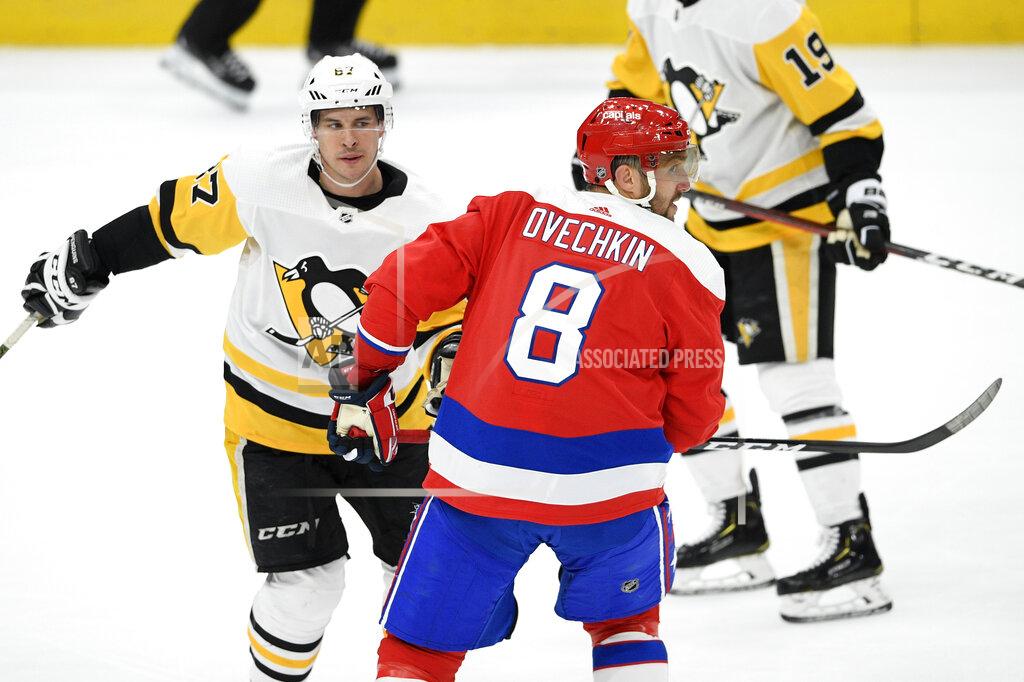 Nick Wass FILE - In this Feb. 2, 2020, file photo, Washington Capitals left wing Alex Ovechkin (8), of Russia, skates next to Pittsburgh Penguins center Sidney Crosby (87) during the third period of an NHL hockey game in Washington. The NHL is embarking on a 56-game regular season with all divisional play in a knock-down, drag-out battle for the Stanley Cup unlike any other in hockey history. (AP Photo/Nick Wass, File)