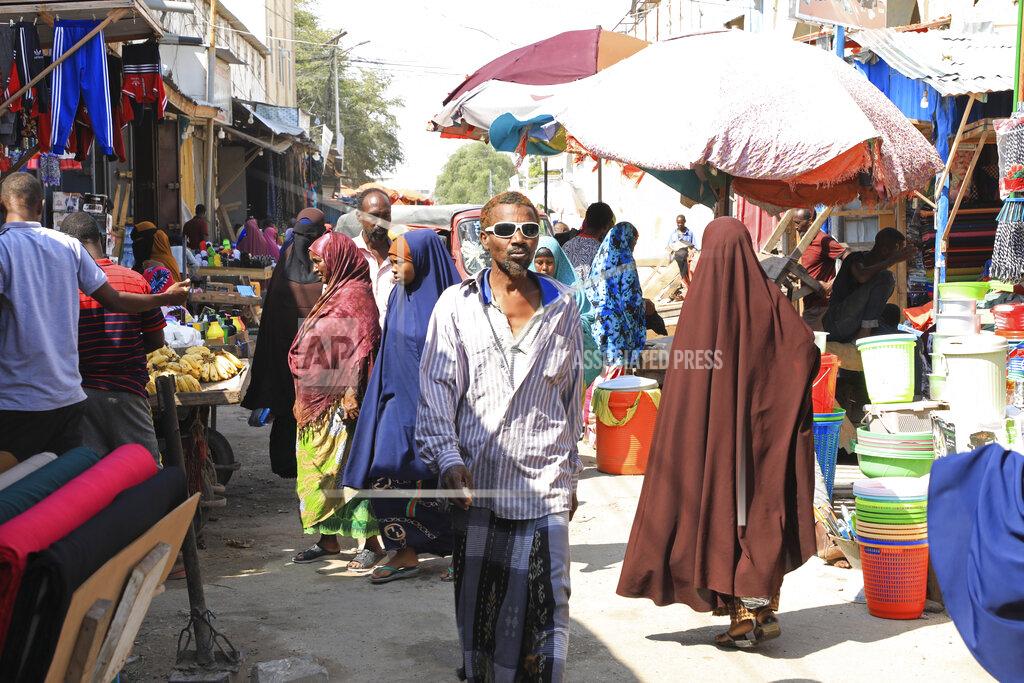 Somalis without facemasks visit the Bakara Market in Mogadishu, Somalia on Wednesday Dec. 2, 2020. As richer countries race to distribute COVID-19 vaccines, Somalia remains the rare place where much of the population hasn't taken the coronavirus seriously. Some fear that’s proven to be deadlier than anyone knows. (AP Photo/Farah Abdi Warsameh)