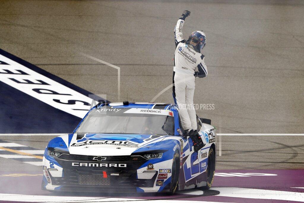 Carlos Osorio Tyler Reddick faces the crowd as he celebrate after winning the NASCAR Xfinity Series auto race at Michigan International Speedway, Saturday, June 8, 2019, in Brooklyn, Mich. (AP Photo/Carlos Osorio)