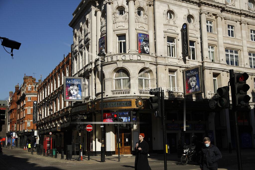 Matt Dunham FILE - In this Friday, Feb. 26, 2021 file photo, signs for Les Miserables are displayed on the temporarily closed Gielgud Theatre during England's third coronavirus lockdown in London. Travelers are packing their bags, café-owners are polishing their cutlery and stage performers are warming up as Britain prepared for a major step out of lockdown. But excitement at the reopening of travel and hospitality vied with anxiety about a more contagious variant spreading in the country (AP Photo/Matt Dunham, File)