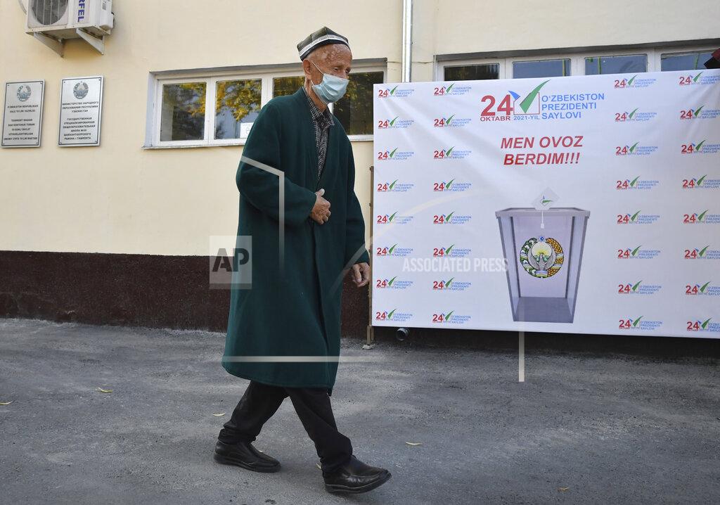 Uncredited A man walks to a polling station during the presidential election in Tashkent, Uzbekistan, Sunday, Oct. 24, 2021. President Shavkat Mirziyoyev, who has relaxed many of the policies of his dictatorial predecessor but has made little effort at political reform, is expected to win a new term by a landslide against weak competition in an election Sunday. (AP Photo)