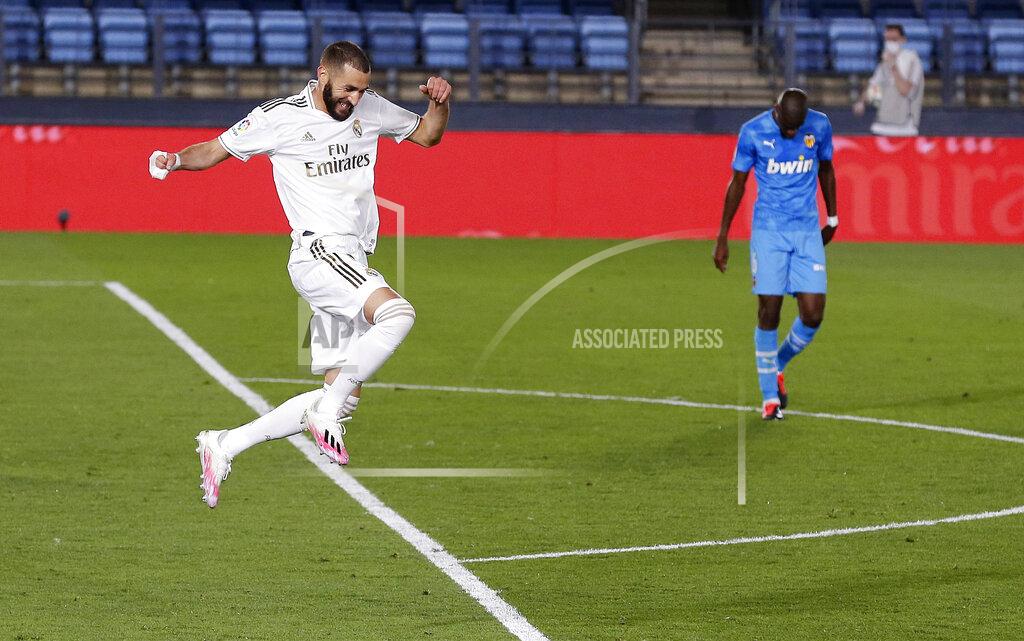 Manu Fernandez Real Madrid's Karim Benzema celebrates after scoring his side's third goal during the Spanish La Liga soccer match between Real Madrid and Valencia at Alfredo di Stefano stadium in Madrid, Spain, Thursday, June 18, 2020. (AP Photo/Manu Fernandez)
