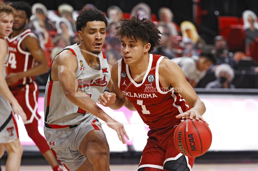 Brad Tollefson Oklahoma's Jalen Hill (1) dribbles around Texas Tech's Micah Peavy (5) during the first half of an NCAA college basketball game Monday, Feb. 1, 2021, in Lubbock, Texas. (AP Photo/Brad Tollefson)