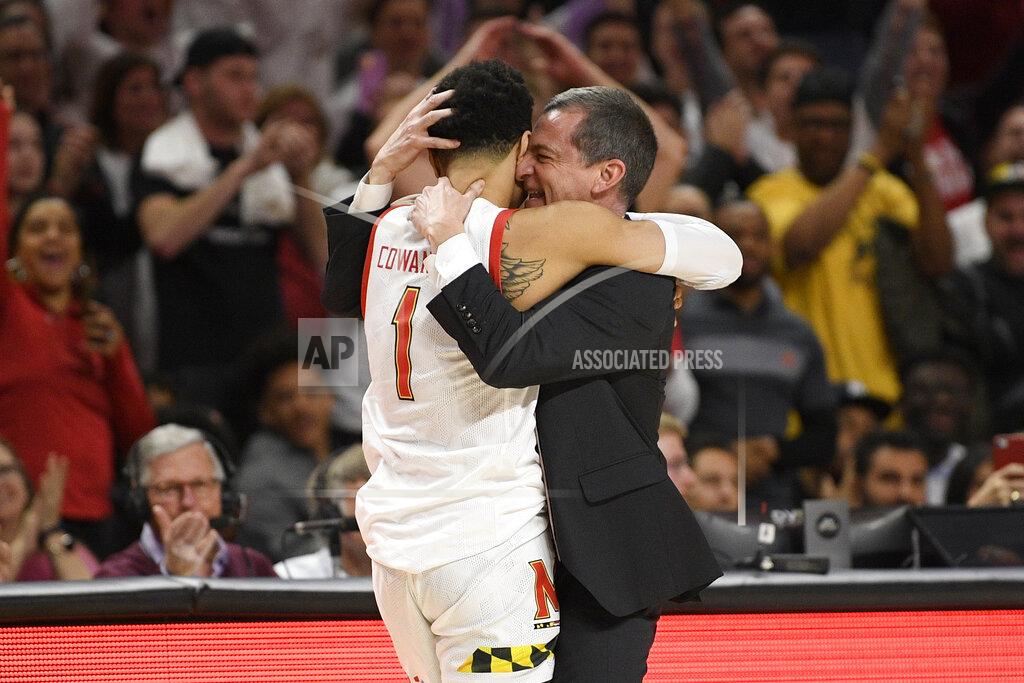 Nick Wass Maryland head coach Mark Turgeon, right, hugs guard Anthony Cowan Jr. (1) after Cowan came out of an NCAA college basketball game against Michigan during the second half Sunday, March 8, 2020, in College Park, Md. (AP Photo/Nick Wass)