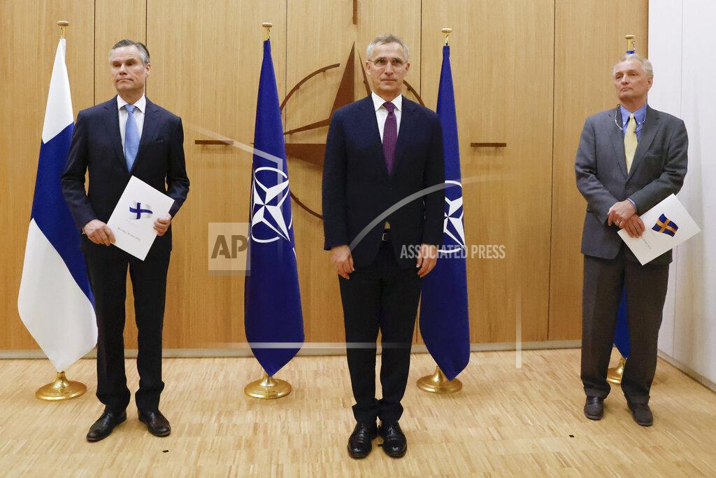 Johanna Geron Finland's Ambassador to NATO Klaus Korhonen, left, NATO Secretary-General Jens Stoltenberg and Sweden's Ambassador to NATO Axel Wernhoff attend a ceremony to mark Sweden's and Finland's application for membership in Brussels, Belgium, Wednesday May 18, 2022. NATO Secretary-General Jens Stoltenberg said that the military alliance stands ready to seize a historic moment and move quickly on allowing Finland and Sweden to join its ranks, after the two countries submitted their membership requests. (Johanna Geron/Pool via AP)