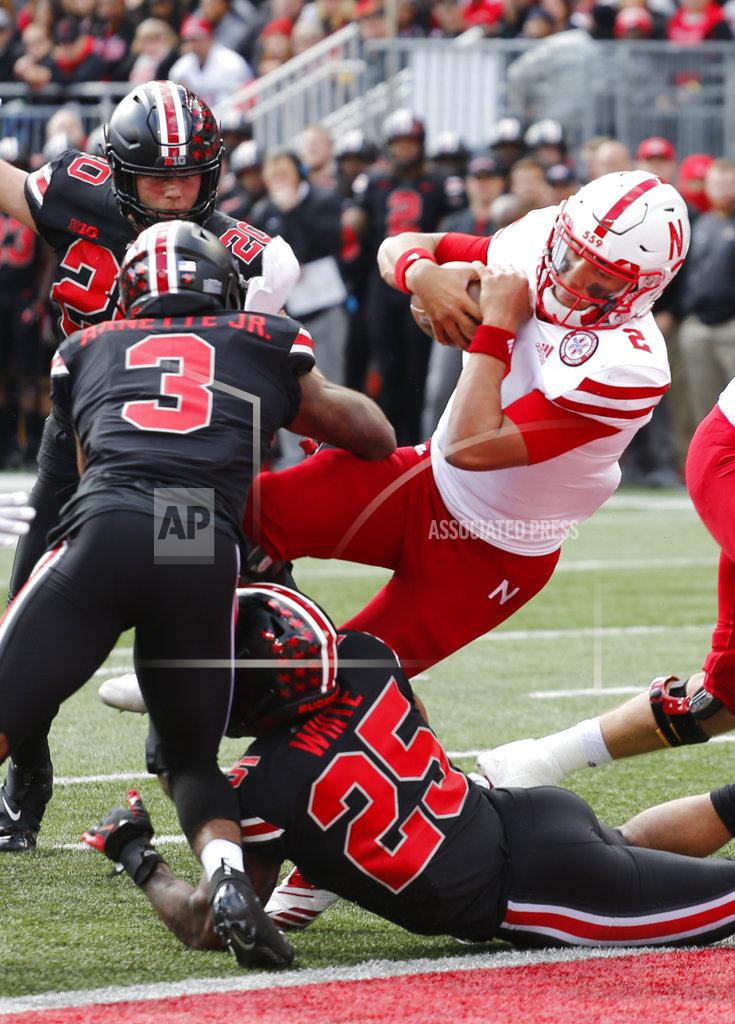 Jay Laprete Nebraska quarterback Adrian Martinez, right, scores a touchdown past Ohio State defenders Damon Arnette, left, and Brendon White during the first half of an NCAA college football game Saturday, Nov. 3, 2018, in Columbus, Ohio. (AP Photo/Jay LaPrete)