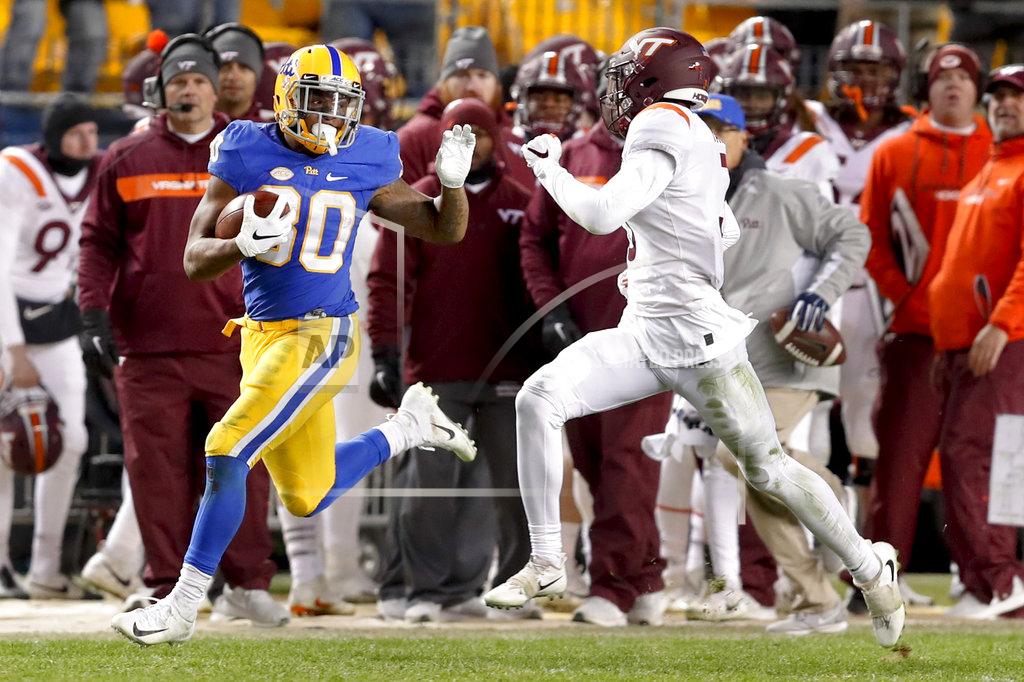 Keith Srakocic Pittsburgh running back Qadree Ollison (30) looks back at Virginia Tech defensive back Caleb Farley (3) as he makes a 97-yard-run for a touchdown in the fourth quarter of an NCAA football game, Saturday, Nov. 10, 2018, in Pittsburgh. Pittsburgh won 52-22.(AP Photo/Keith Srakocic)