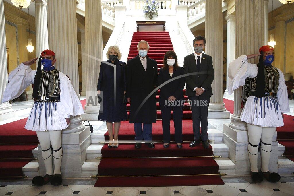 Orestis Panagiotou Greek President Katerina Sakellaropoulou, second right, her partner Pavlos Kotsonis, right, Britain's Prince Charles Charles, second left, and his wife Camilla, the Duchess of Cornwall pose for the photographers at the Presidential Palace in Athens, Thursday, March 25, 2021. Fighter jets flew by the ancient Acropolis and tanks rumbled past parliament in central Athens as Greece's celebrations for the bicentenary of the nation's war of independence culminated in a military parade attended by dignitaries from Britain, France and Russia but no public. (Orestis Panagiotou/Pool via AP)