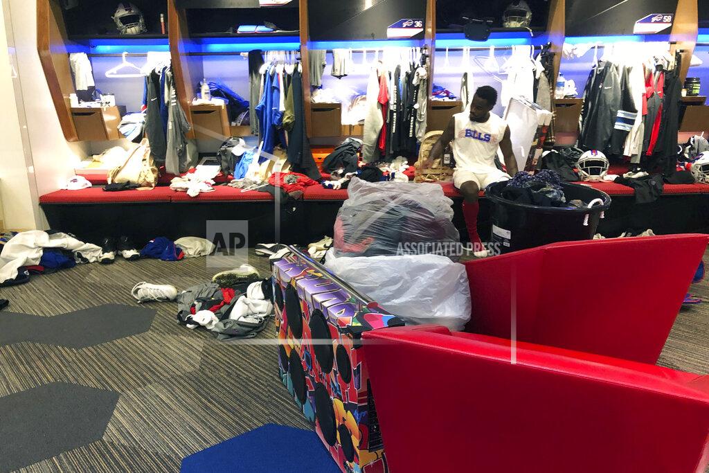 Buffalo Bills NFL football wide receiver Isaiah McKenzie sits at his locker after practice on Monday, Aug. 26, 2019, in Orchard Park, N.Y., with all the worldly possessions he brought to Buffalo stored in front of him. He’s got a collection of clothes in one large bucket, and more in two plastic bags, plus an oversized colorful boombox. The third-year player does this as motivation by reminding himself how uncertain his future is with NFL teams making their final cuts by Saturday. And it’s also a way of being ready to travel in an instant, should McKenzie get cut by the team. (AP Photo/John Wawrow)