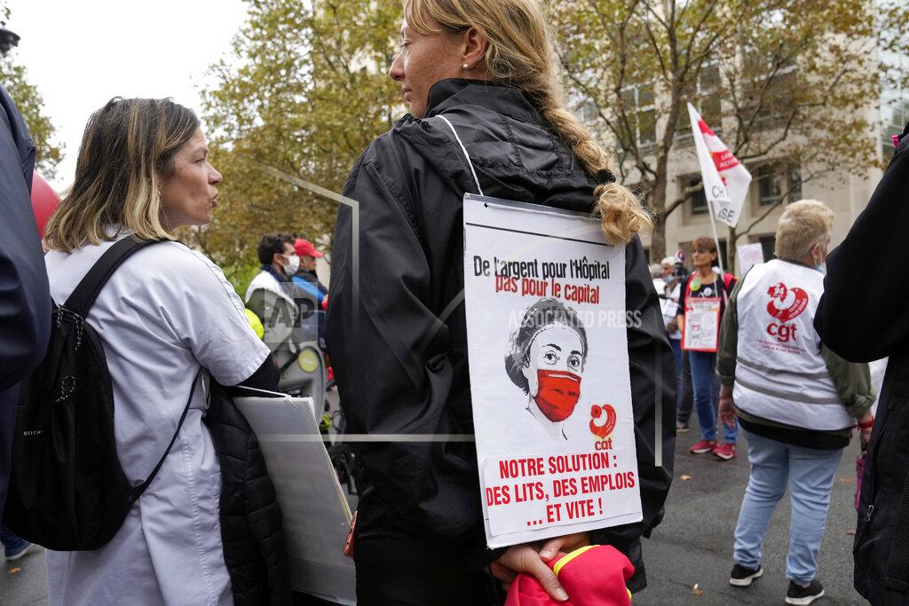 Francois Mori A medical worker holds a placard reading : "Money for Hospital, Not for the Capital, Our Solution Hospitals beds, Employs and quick", during a protest gathering outside the Health Ministry, in Paris, Tuesday, Sept. 14, 2021 against a law requiring them to get vaccinated by Wednesday or risk suspension from their jobs. The law is aimed at protecting patients from new surges of COVID-19. Most of the French population is vaccinated but a vocal minority are against the vaccine mandate. (AP Photo/Francois Mori)