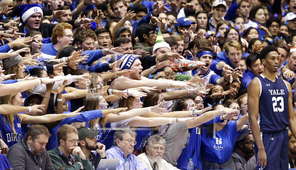 Gerry Broome FILE - In this Dec. 8, 2018, file photo, Duke fans cheer as Yale's Jordan Bruner (23) waits to inbound the ball during the first half of an NCAA college basketball game in Durham, N.C. As lock-downs are lifted, restrictions on social gatherings eased and life begins to resemble some sense, sports are finally starting to emerge from the coronavirus pandemic. Many sports business experts believe those hardy fans will be the first to return. (AP Photo/Gerry Broome, File)