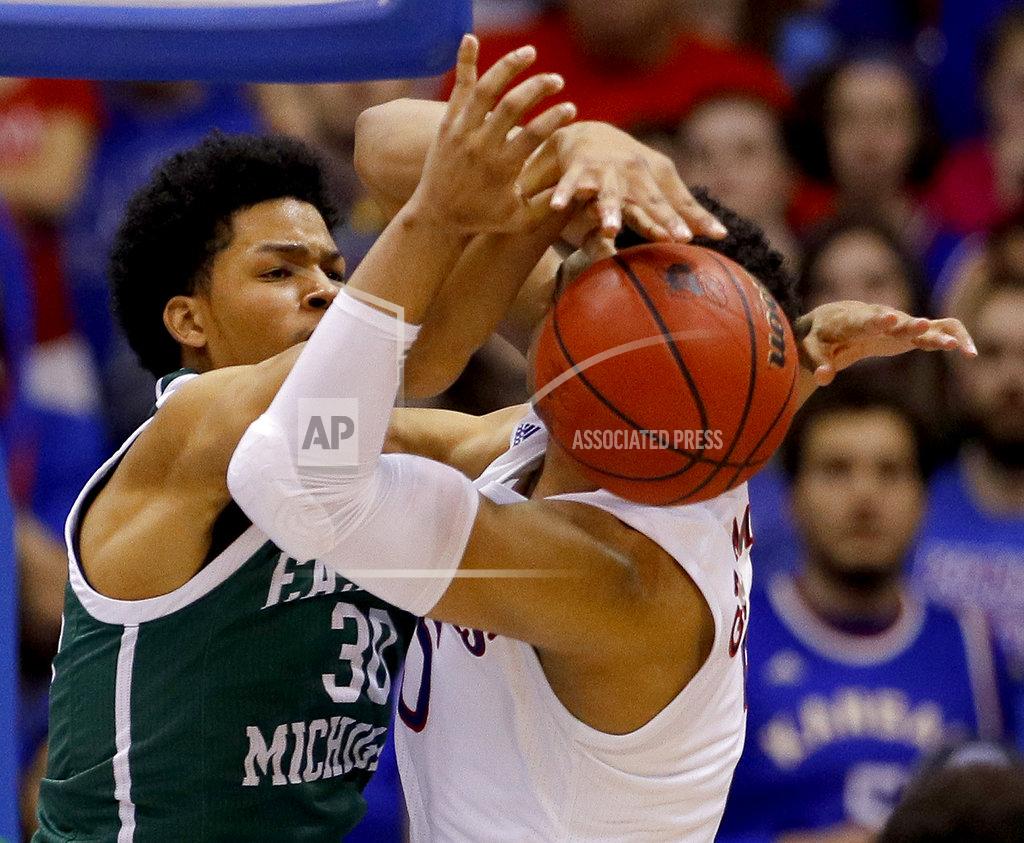 Charlie Riedel Eastern Michigan's Jalen King (30) tries to steal the ball from Kansas' Quentin Grimes during the second half of an NCAA college basketball game Saturday, Dec. 29, 2018, in Lawrence, Kan. Kansas won 87-63. (AP Photo/Charlie Riedel)