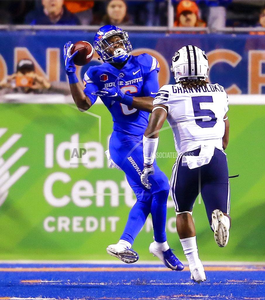 Steve Conner Boise State wide receiver CT Thomas (6) catches the ball on a 31-yard reception in front of BYU defensive back Dayan Ghanwoloku (5) during the first half of an NCAA college football game Saturday, Nov. 3, 2018, in Boise, Idaho. (AP Photo/Steve Conner)