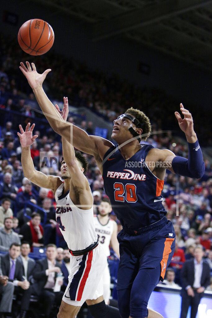 Young Kwak Pepperdine forward Kameron Edwards (20) and Gonzaga guard Ryan Woolridge (4) go after a rebound during the first half of an NCAA college basketball game in Spokane, Wash., Saturday, Jan. 4, 2020. (AP Photo/Young Kwak)