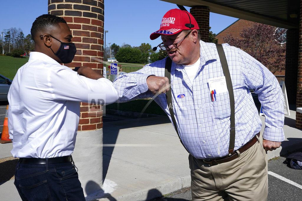 Steve Helber CORRECTS MONTH TO NOVEMBER Democratic Congressional candidate, Cameron Webb, left, does an elbow bump with Virginia Del. Matt Fariss, R-Rustburg, outside a polling place in Rustburg, Va., Tuesday Nov. 3, 2020. Webb is facing Republican Bob Good in today's election. (AP Photo/Steve Helber)