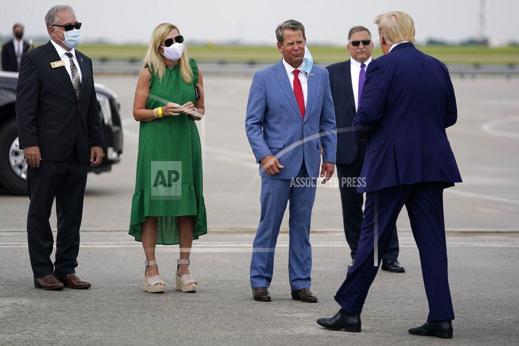Georgia Gov. Brian Kemp, third from left, greets President Donald arrives at Hartsfield-Jackson International Airport, Wednesday, July 15, 2020, in Atlanta. (AP Photo/Evan Vucci)