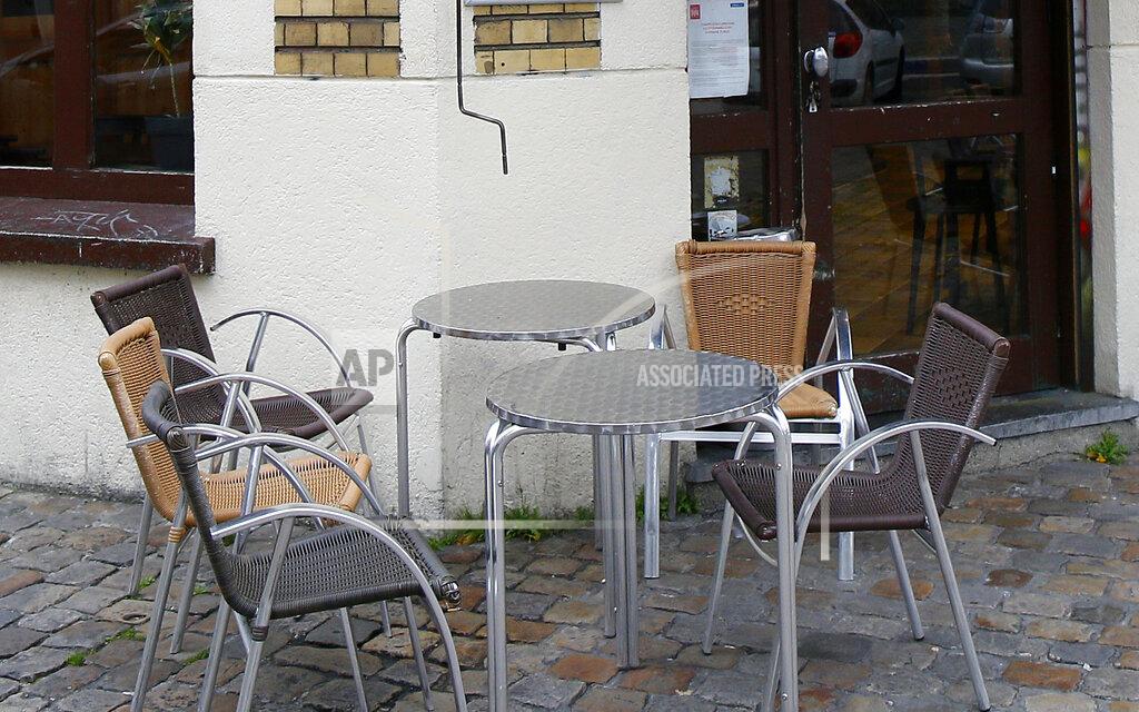FILE - In this file photo dated Thursday, Oct.8, 2020, empty tables at a cafe terrace in Lille, northern France. The Paris prosecutor’s office on Monday April 5, 2021, announced an investigation into accusations that government ministers and others dined in secret unidentified restaurants in violation of pandemic restrictions. (AP Photo/Michel Spingler, FILE)