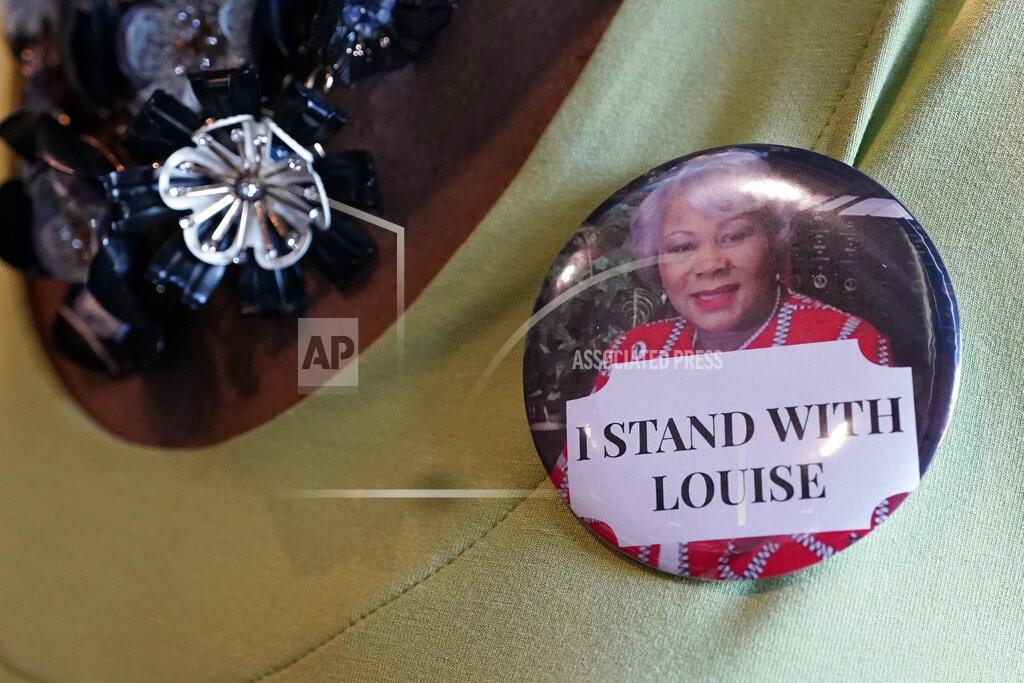 Virginia state Sen. Louise Lucas, D-Portsmouth, center, wears a "I Stand With Louise" button during the Virginia Senate Special Session in the temporary Senate chambers at the Science Museum of Virginia Tuesday Aug. 18, 2020, in Richmond, Va. Lucas has been charged in the removal of a Confederate statue in Portsmouth. (AP Photo/Steve Helber, Pool)