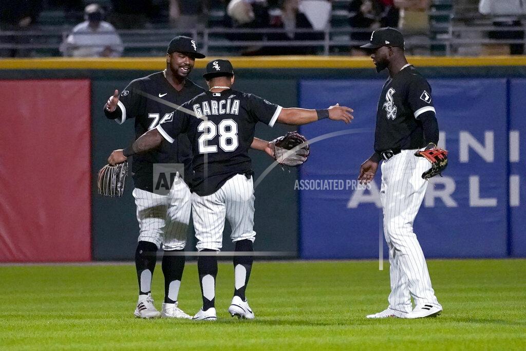 Charles Rex Arbogast The Chicago White Sox outfielders Eloy Jimenez, Leury Garcia and Luis Robert, from left, celebrate the team's 9-3 win over the Los Angeles Angels in a baseball game Tuesday, Sept. 14, 2021, in Chicago. (AP Photo/Charles Rex Arbogast)