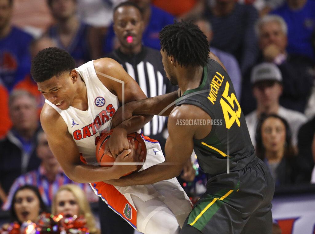Matt Stamey Baylor guard Davion Mitchell (45) forces a jump ball with Florida guard Noah Locke (10) during the second half of an NCAA college basketball game Saturday, Jan. 25, 2020, in Gainesville, Fla. (AP Photo/Matt Stamey)