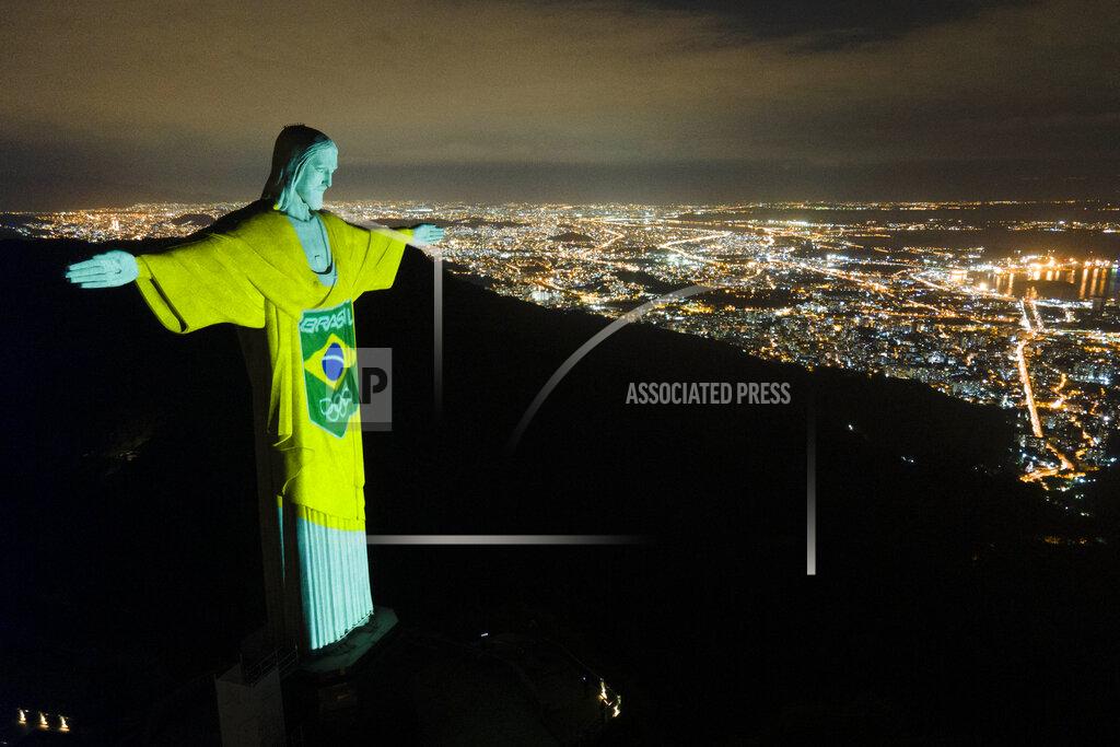 Lucas Dumphreys The colors of the Brazilian Olympic team are projected on the statue of Christ the Redeemer by the Brazilian Olympic Committee as a reminder of how sport can inspire in the fight against COVID-19, one hundred days before the Tokyo Olympic Games, in Rio de Janeiro, Brazil, Wednesday, April 14, 2021. (AP Photo/Lucas Dumphreys)