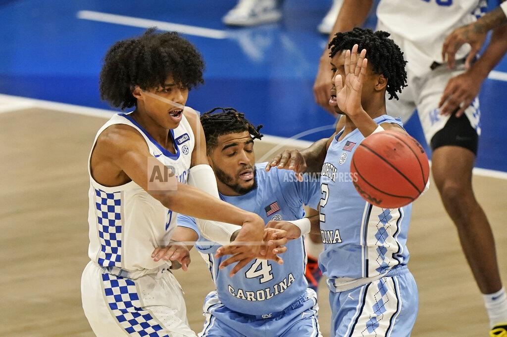 Tony Dejak Kentucky's Brandon Boston Jr., left, passes against North Carolina in the first half of an NCAA college basketball game, Saturday, Dec. 19, 2020, in Cleveland. (AP Photo/Tony Dejak)