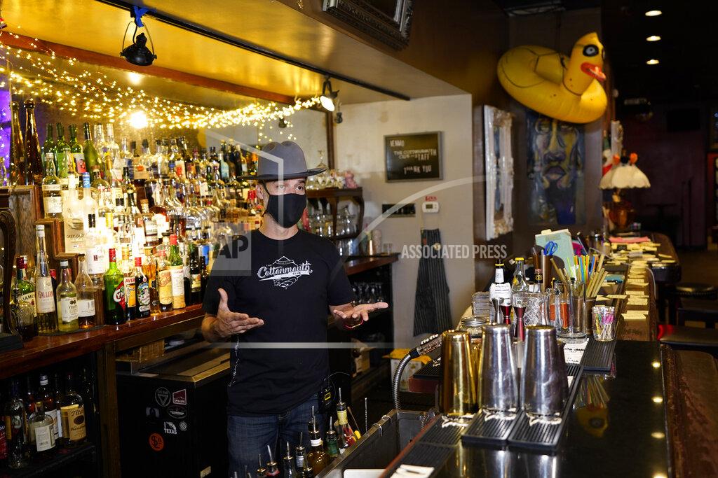 David J. Phillip Michael Neff, co-owner of the Cottonmouth Club, talks about his bar Tuesday, June 23, 2020, in Houston. Neff closed his downtown bar because of concerns within the industry as the number COVID-19 case continues to rise in Houston. (AP Photo/David J. Phillip)