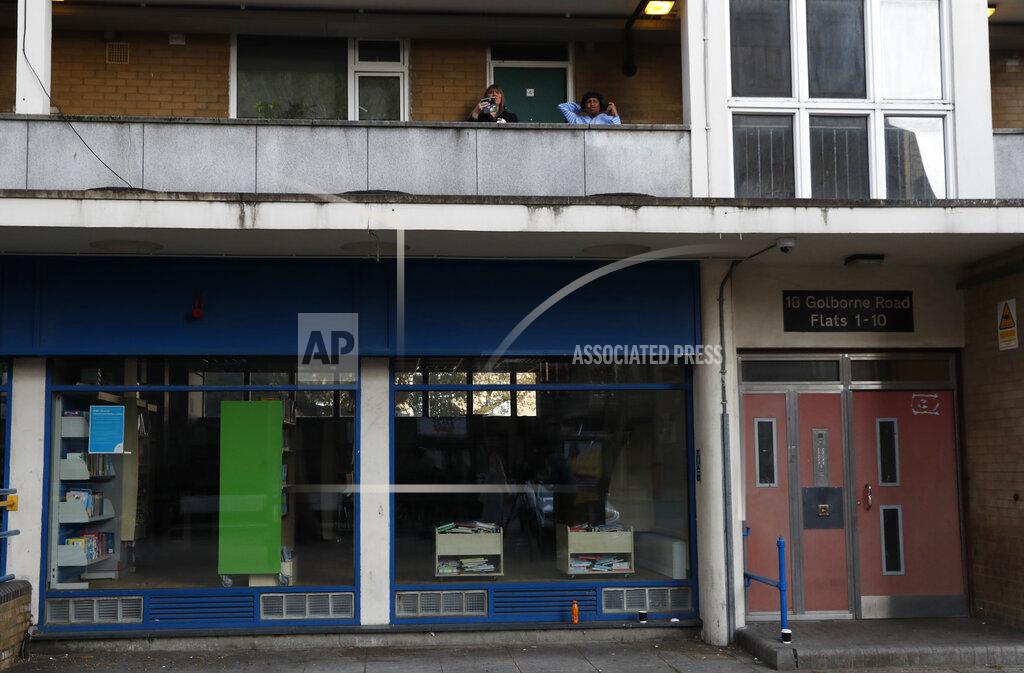 Alastair Grant People look down from their homes in the Ladbroke Grove area of west London during a campaign stop by the Conservative party candidate for London Mayor Shaun Bailey on Thursday, April 29, 2021. (AP Photo/Alastair Grant)