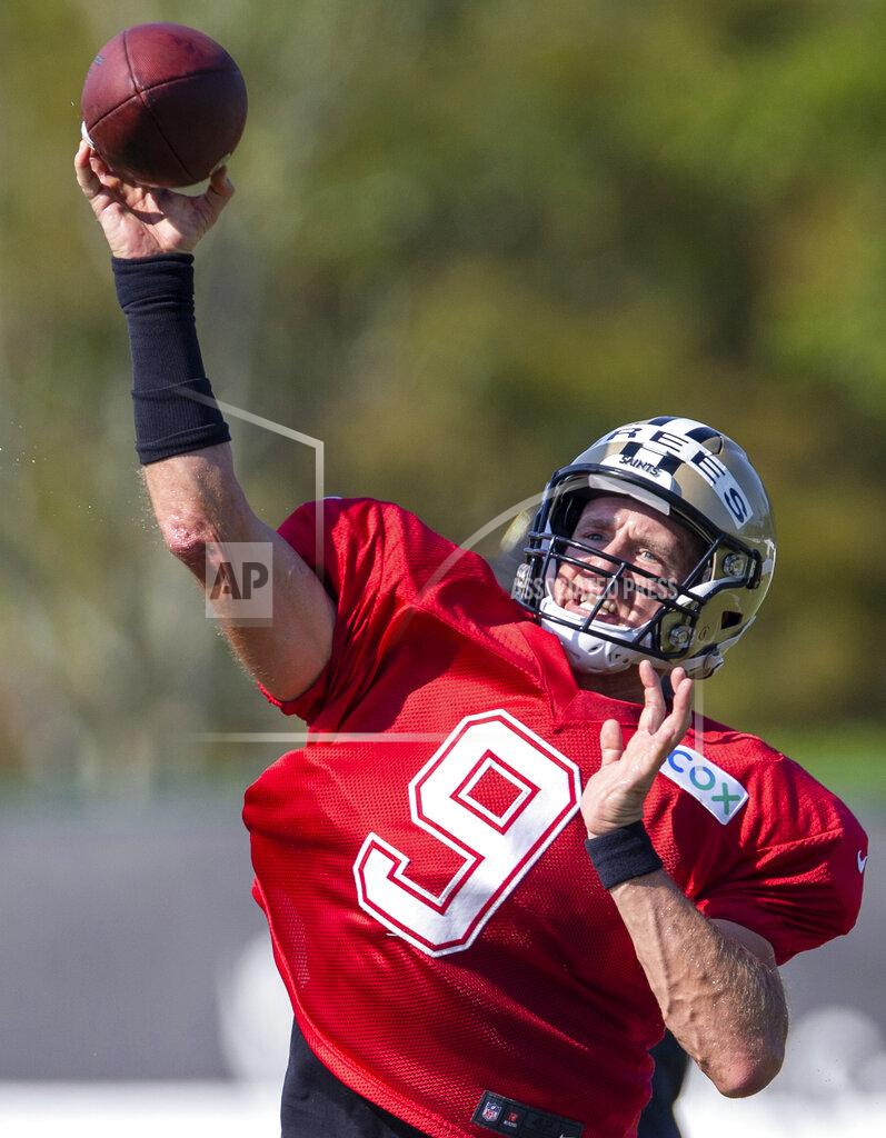 David Grunfeld FILE - New Orleans Saints quarterback Drew Brees (9) throws the ball during NFL football training camp in Metairie, La., Friday, Aug. 21, 2020. Tom Brady has shifted the NFC South spotlight to Tampa Bay, but Drew Brees and the New Orleans Saints are still the three-time defending division champions. The battle of the NFL’s all-time leading passers brings extra drama to the division race. (David Grunfeld/The Advocate via AP, Pool)