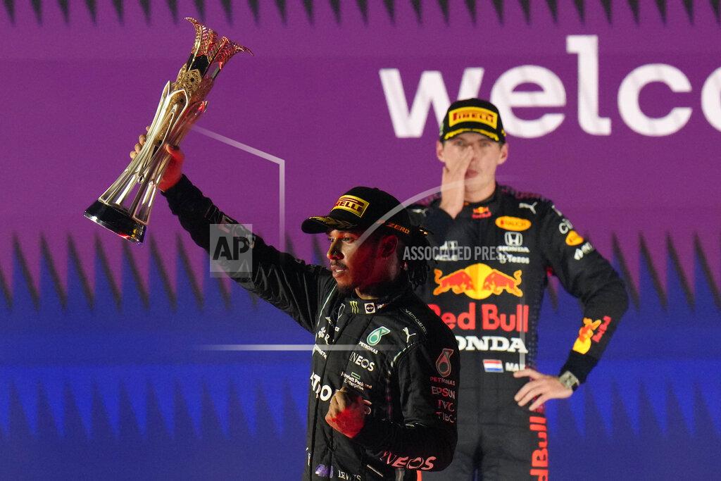 Hassan Ammar Mercedes driver Lewis Hamilton of Britain celebrates winning the Formula One Saudi Arabian Grand Prix in front of the second placed Red Bull driver Max Verstappen of the Netherlands, in Jiddah, Sunday, Dec. 5, 2021. (AP Photo/Hassan Ammar)