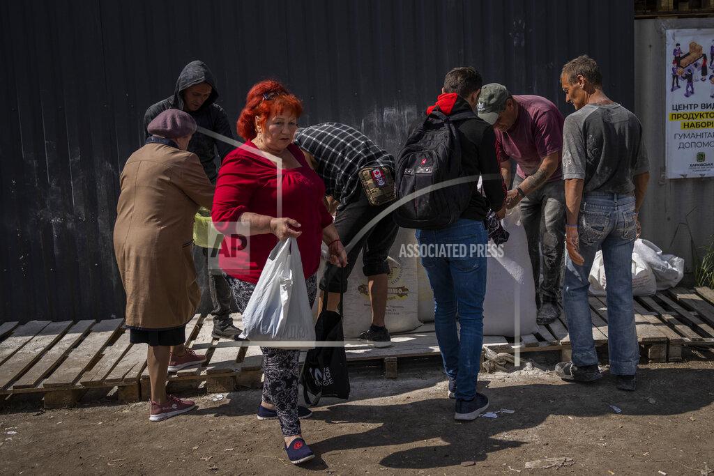 Bernat Armangue People receive flour at a food donation spot in Kharkiv, eastern Ukraine, Monday, May 23, 2022. (AP Photo/Bernat Armangue)