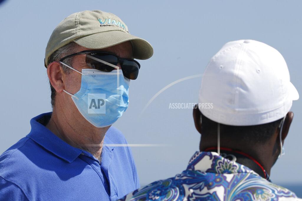 Steve Helber Virginia Gov. Ralph Northam talks with a legislator as he looks over two of the offshore wind turbines off the coast of Virginia Beach, Va., Monday, June 29, 2020. Two wind turbines have been constructed 20 miles off the coast of Virginia Beach as part of an offshore wind turbine project. The turbines will begin operation in August. (AP Photo/Steve Helber)