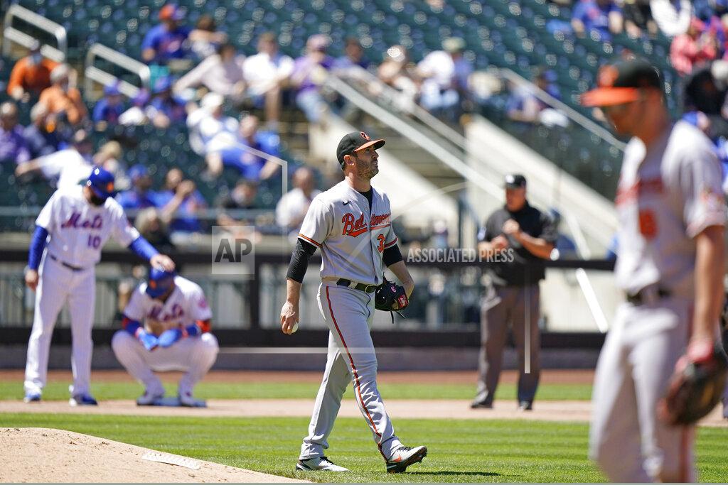 Kathy Willens Baltimore Orioles starting pitcher Matt Harvey, center, looks to the outfield with a Mets runner on third during the fifth inning of a baseball game, Wednesday, May 12, 2021, in New York. Harvey allowed seven earned runs in four and a third innings against his former team. (AP Photo/Kathy Willens)