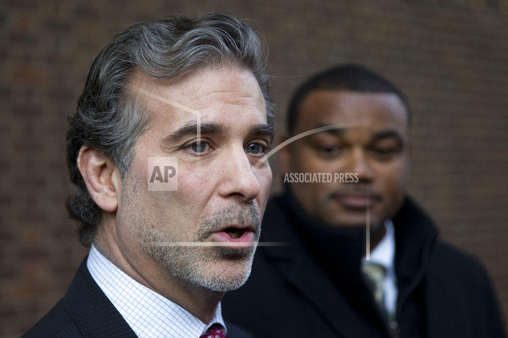 Matt Rourke FILE - In this Nov. 19, 2014, file photo, co-lead players' lawyer Christopher Seeger, left, and client former NFL player Shawn Wooden speak with members of the media after a hearing on the proposed NFL concussion settlement outside of the U.S. Courthouse in Philadelphia. After several years of infighting over $112 million in legal fees in the NFL concussion case, a federal appeals court has approved a plan to give nearly half the money to Seeger's firm. The decision Thursday, May 7, 2020, grants New York-based Seeger Weiss over $51 million, more than 10 times the amount of any other firm, including the lawyers who filed the first cases in 2012. (AP Photo/Matt Rourke, File)