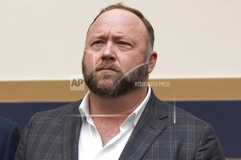 FILE - This Tuesday, Dec. 11, 2018 file photo shows radio show host and conspiracy theorist Alex Jones at Capitol Hill in Washington. On Thursday, April 9, 2020, the U.S. Food and Drug Administration sent a warning letter ordering Jones to stop falsely claiming that toothpaste, mouth wash and other products sponsored by his show can help prevent COVID-19. (AP Photo/J. Scott Applewhite)