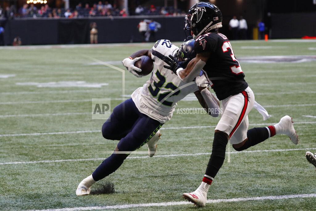 John Bazemore Seattle Seahawks running back Chris Carson (32) runs into the end zone against Atlanta Falcons free safety Ricardo Allen (37) during the first half of an NFL football game, Sunday, Oct. 27, 2019, in Atlanta. (AP Photo/John Bazemore)