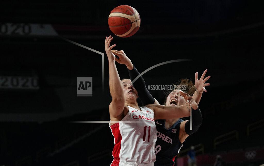 Eric Gay Canada's Natalie Achonwa (11), left, and South Korea's Ji Su Park (19) scramble for a rebound during women's basketball preliminary round game at the 2020 Summer Olympics, Thursday, July 29, 2021, in Saitama, Japan. (AP Photo/Eric Gay)