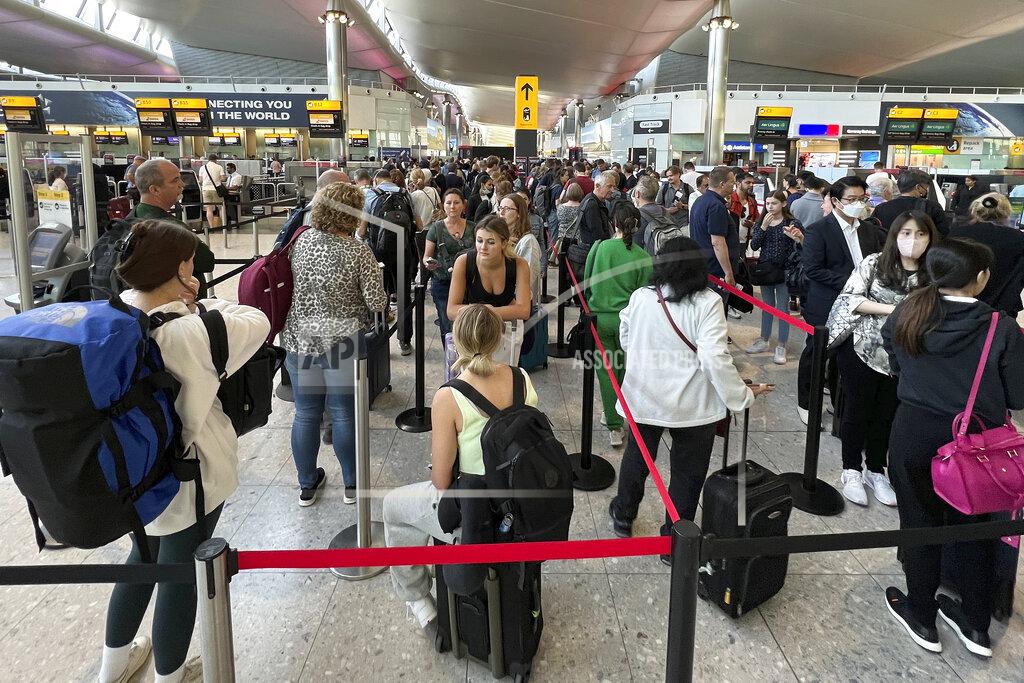 Frank Augstein FILE - Travellers queue at security at Heathrow Airport in London, Wednesday, June 22, 2022. People face travelling disruption and long queues at airports amid the industry's ongoing staffing crisis. After two years of pandemic restrictions, travel demand is back with a vengeance but airlines and airports that slashed jobs during the depths of the COVID-19 crisis are struggling to keep up. With the busy summer tourism season underway in Europe, passengers are encountering chaotic scenes at airports, including lengthy delays, canceled flights and headaches over lost luggage. (AP Photo/Frank Augstein, File)