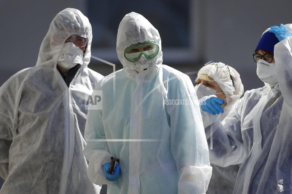 Sergei Grits Belarusian healthcare workers wearing face masks and costumes to protect from coronavirus stand outside a hospital in Minsk, Belarus, Tuesday, April 14, 2020. The highly contagious COVID-19 coronavirus pandemic is known to be a greater threat to the health of older people.(AP Photo/Sergei Grits)